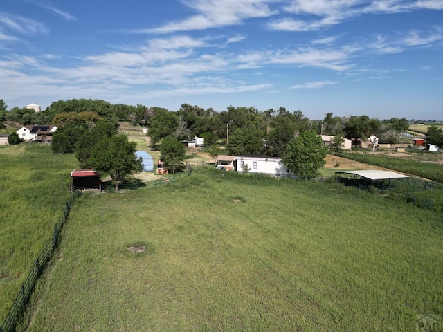 view of yard with a rural view and fence