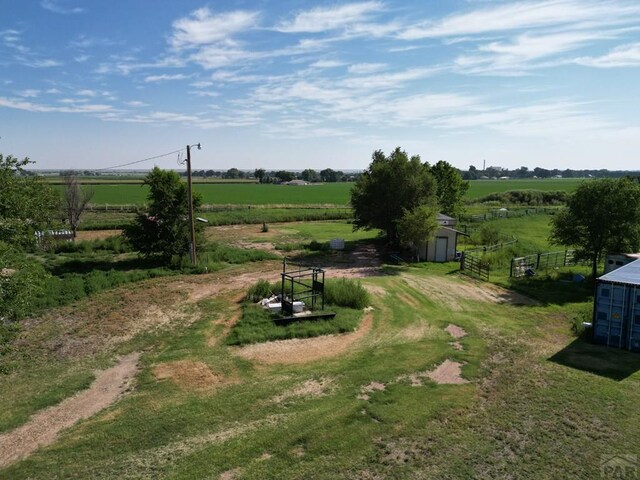 view of yard featuring fence and a rural view