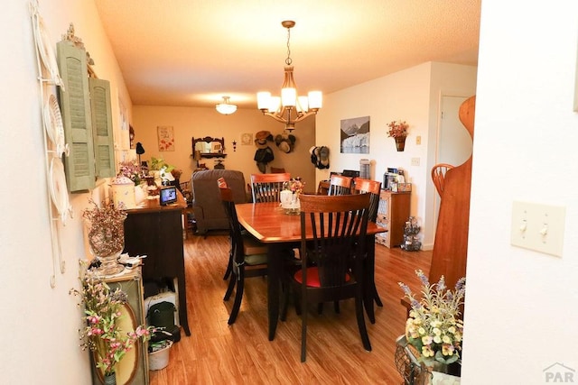 dining space featuring a chandelier and wood finished floors