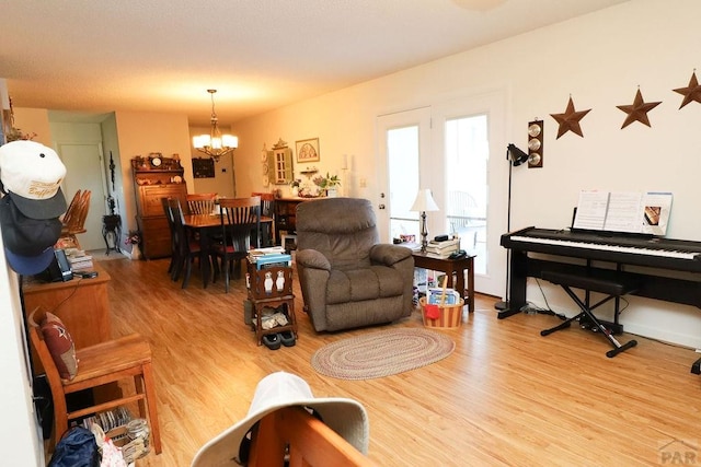 living room featuring light wood finished floors and a notable chandelier