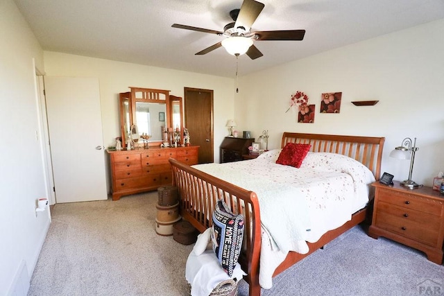 bedroom featuring light colored carpet and ceiling fan