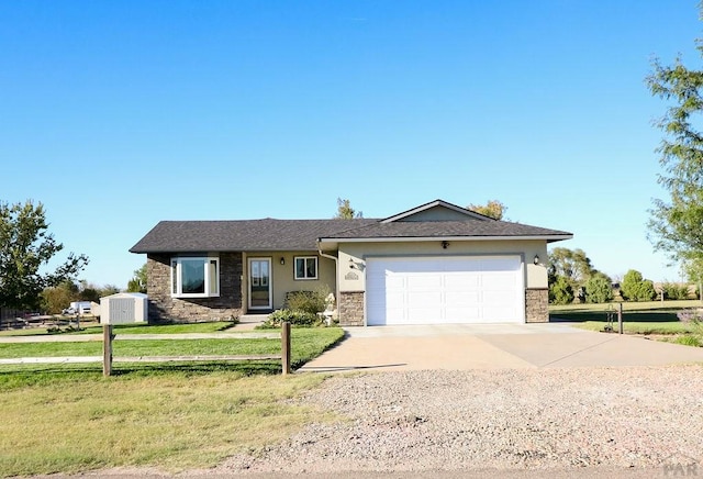 ranch-style home featuring a garage, stucco siding, concrete driveway, and a front yard