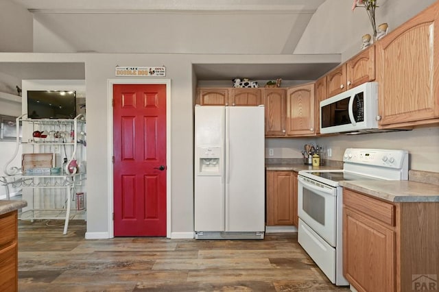 kitchen with white appliances, light countertops, and dark wood-style flooring