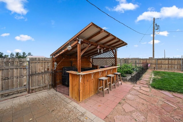 view of patio / terrace with a fenced backyard and outdoor dry bar