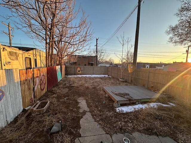 view of yard featuring a fenced backyard and a deck