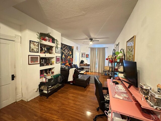 office featuring a ceiling fan, a textured ceiling, and wood finished floors