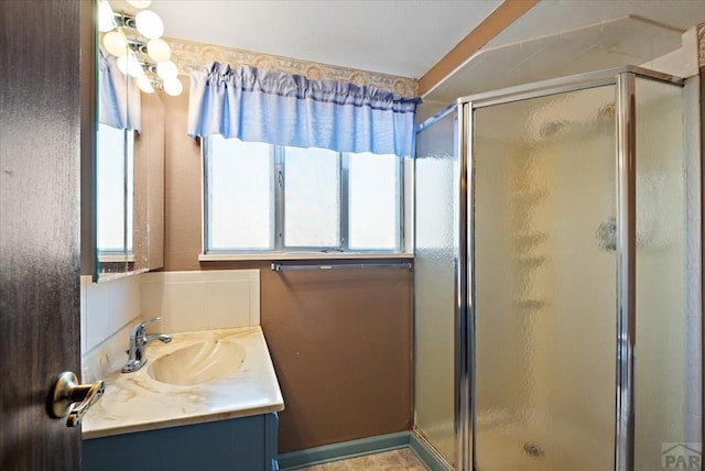 full bath with vanity and a shower stall