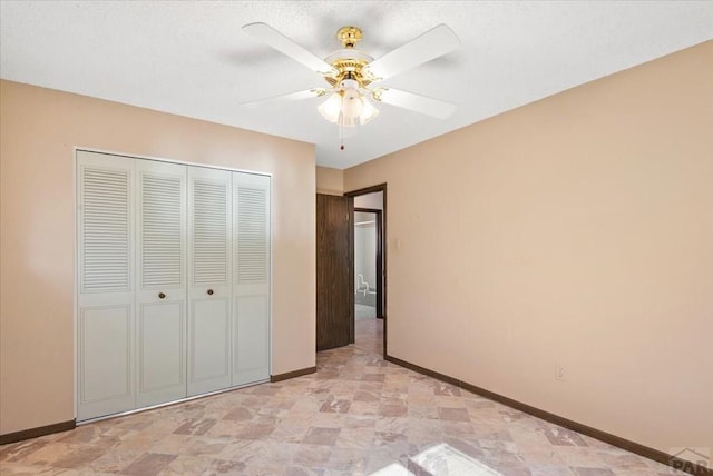 unfurnished bedroom with a closet, baseboards, and a ceiling fan