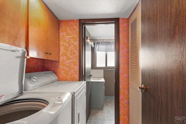 laundry room featuring laundry area, separate washer and dryer, and a sink