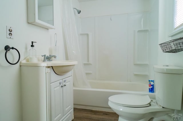 full bathroom featuring toilet, wood finished floors, vanity, and shower / bath combination with curtain