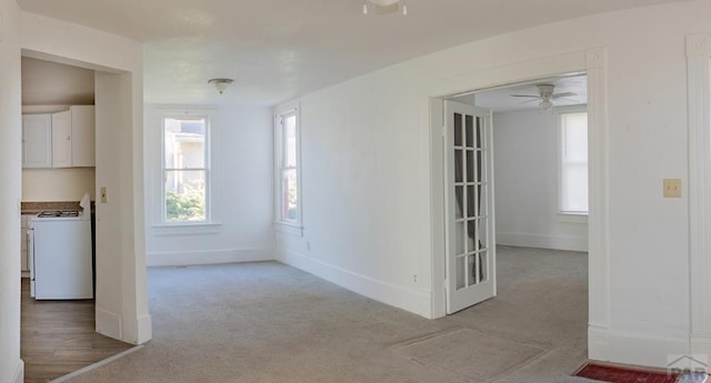 interior space with baseboards and a ceiling fan