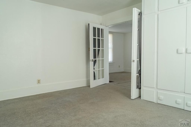 spare room with light colored carpet