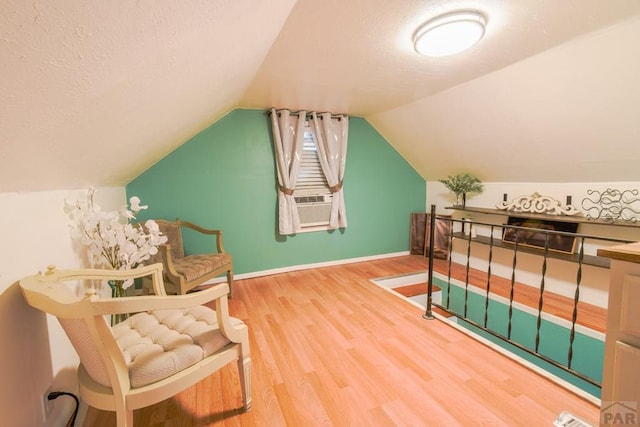 1232 Spruce St, Pueblo, CO 81004 - bonus room featuring wood finished floors, a textured ceiling, lofted ceiling, baseboards, and cooling unit