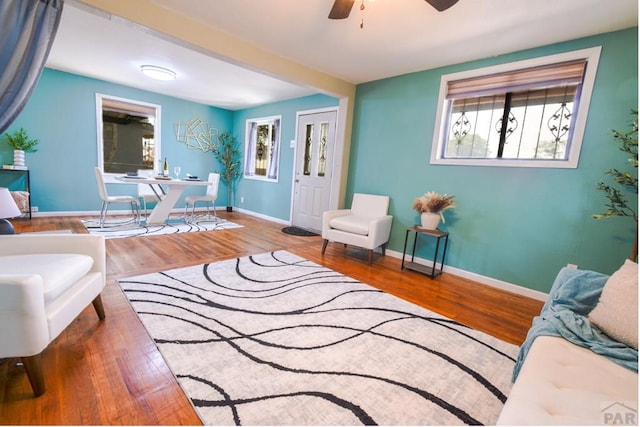 1232 Spruce St, Pueblo, CO 81004 - living area featuring wood finished floors, a ceiling fan, and baseboards