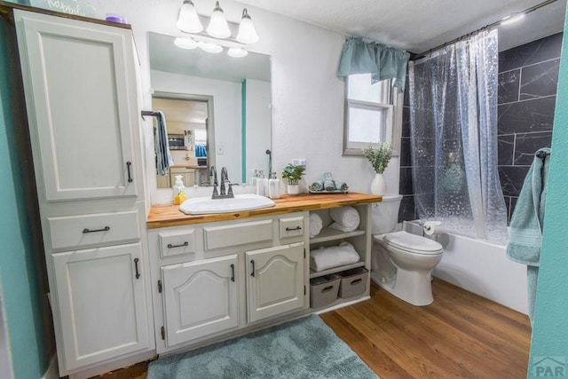 1232 Spruce St, Pueblo, CO 81004 - bathroom featuring vanity, toilet, shower / bath combo with shower curtain, wood finished floors, and a chandelier