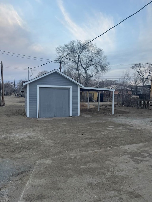 detached garage featuring a carport