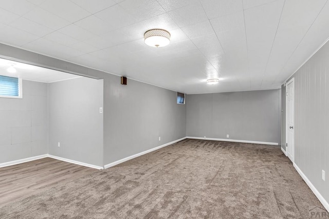 below grade area with baseboards and carpet