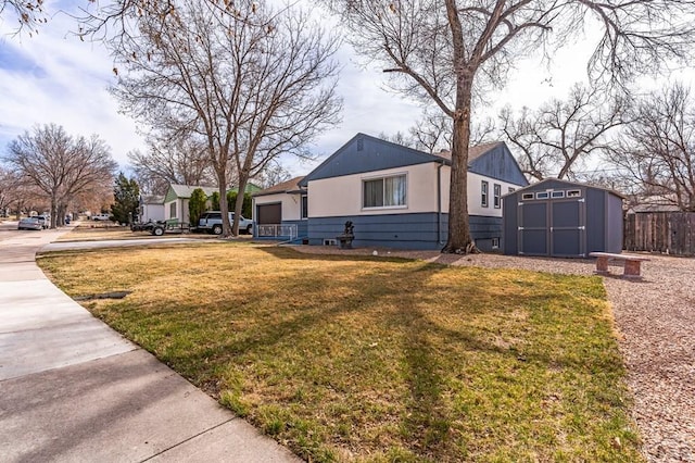 exterior space featuring an outbuilding, fence, a shed, a front lawn, and a garage