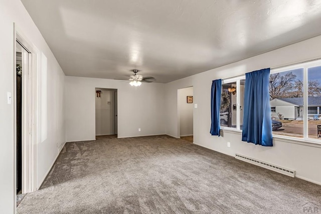 carpeted empty room with a ceiling fan and baseboard heating