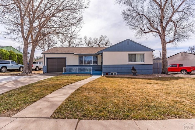 view of front of property featuring a garage, a porch, concrete driveway, and a front lawn