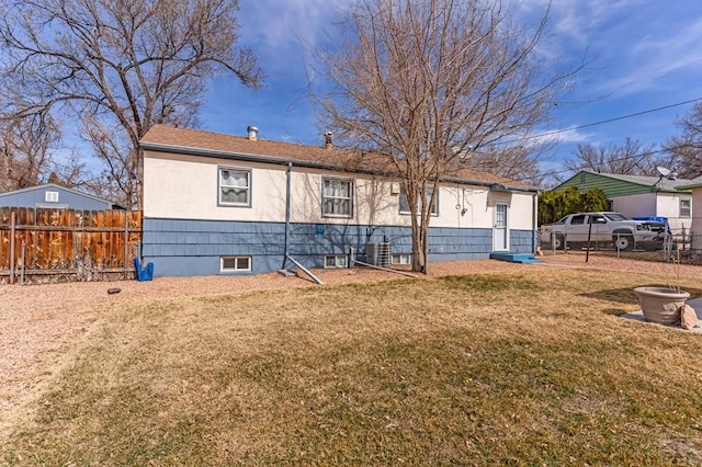 view of front facade with a front lawn and fence