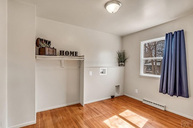 laundry room with baseboards, laundry area, hookup for a washing machine, wood finished floors, and a baseboard radiator