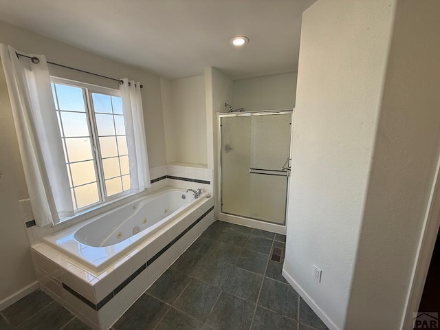 full bath with a stall shower, baseboards, tile patterned flooring, and a tub with jets