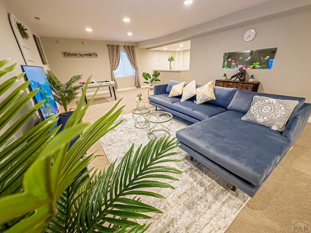 carpeted living area with recessed lighting and baseboards