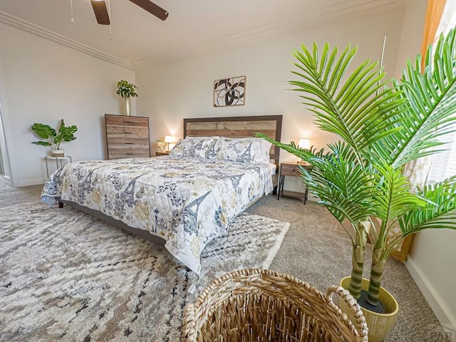 bedroom featuring carpet, baseboards, ceiling fan, and crown molding