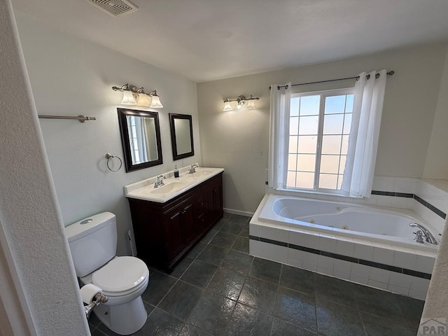 full bathroom with a whirlpool tub, visible vents, a sink, and toilet