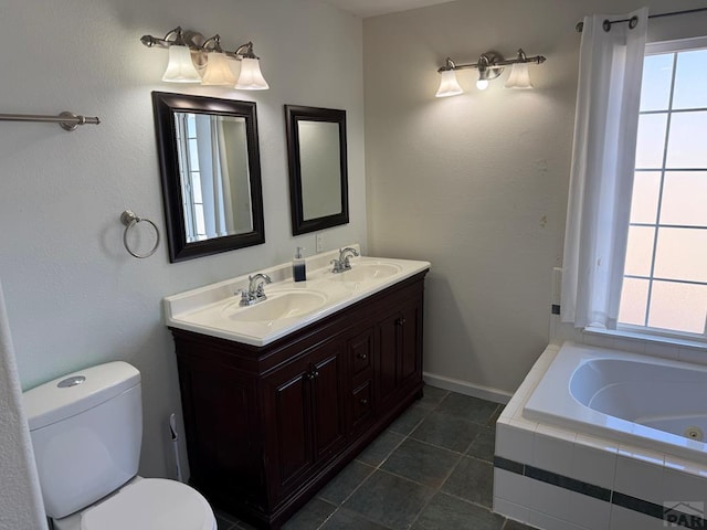 bathroom with plenty of natural light, a sink, and toilet