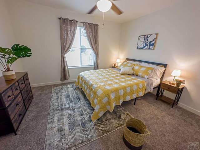 carpeted bedroom featuring baseboards and a ceiling fan