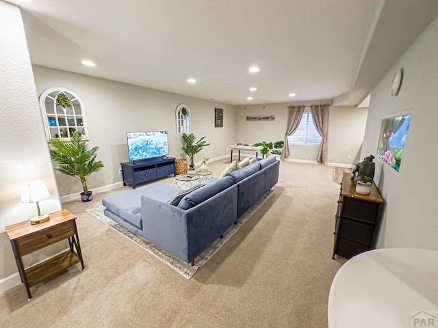 living area with recessed lighting, light carpet, and baseboards