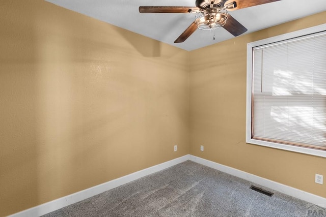 carpeted spare room with visible vents and baseboards