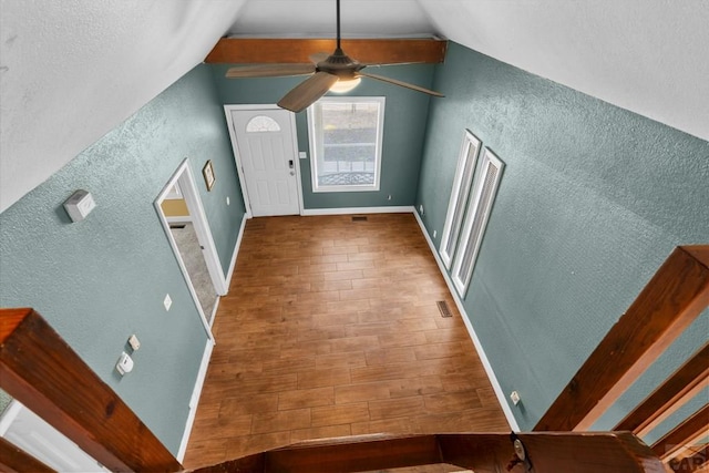 bonus room featuring visible vents, a ceiling fan, a textured wall, wood finished floors, and vaulted ceiling