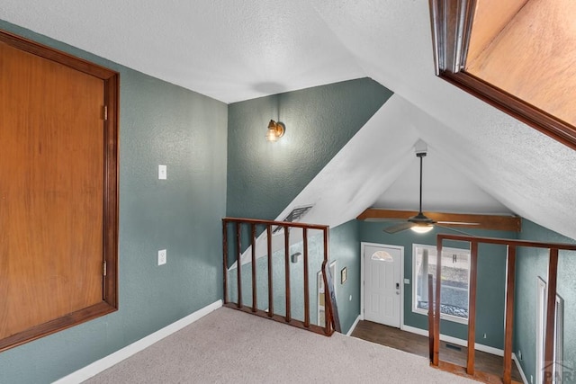 bonus room featuring vaulted ceiling, a textured ceiling, baseboards, and stairs