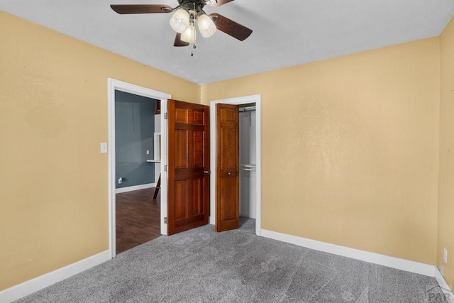 unfurnished bedroom with ceiling fan, a closet, baseboards, and carpet flooring