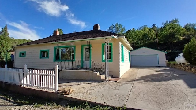 view of front of property featuring a porch, an outbuilding, and a garage