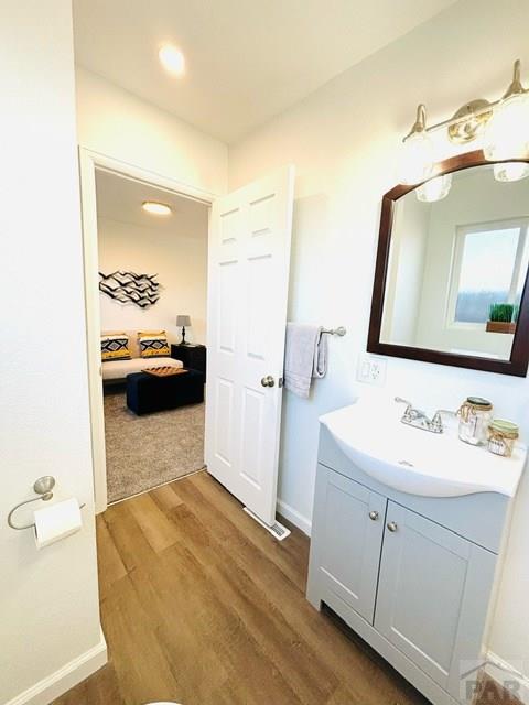 521 Tyler St, Pueblo, CO 81004 - ensuite bathroom with wood finished floors, vanity, baseboards, and recessed lighting