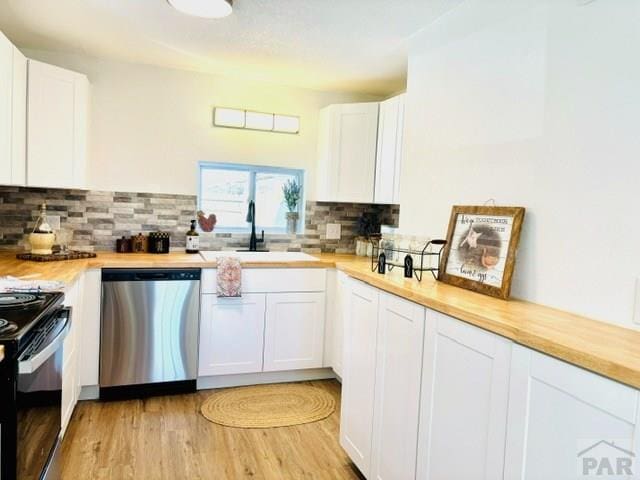 521 Tyler St, Pueblo, CO 81004 - kitchen featuring dishwasher, black range with electric stovetop, a sink, and white cabinetry