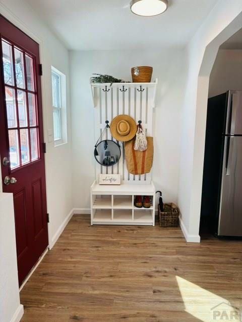 521 Tyler St, Pueblo, CO 81004 - mudroom with wood finished floors, baseboards, and arched walkways