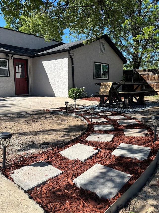 521 Tyler St, Pueblo, CO 81004 - rear view of house featuring stucco siding, fence, and a patio