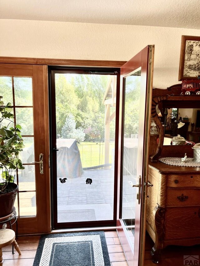 entryway with light tile patterned floors