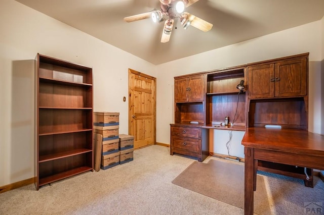 office space with a ceiling fan, light carpet, and baseboards