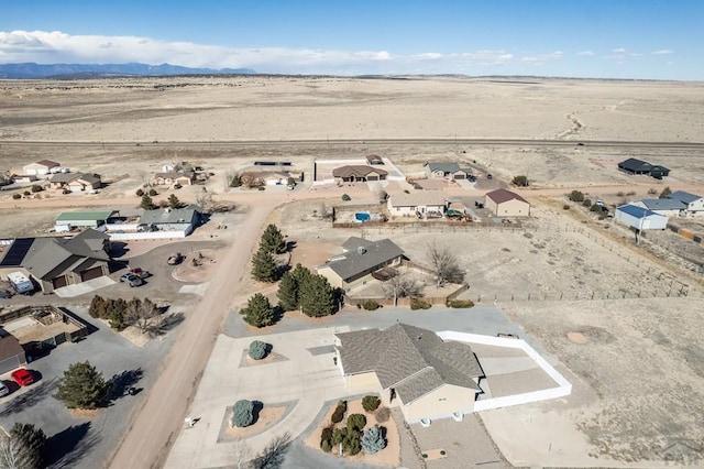 birds eye view of property with view of desert and a mountain view