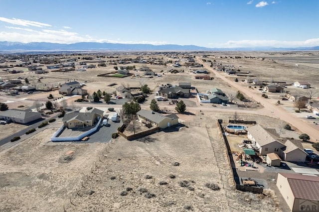 bird's eye view with a mountain view and view of desert