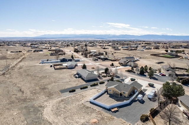 drone / aerial view featuring view of desert and a mountain view