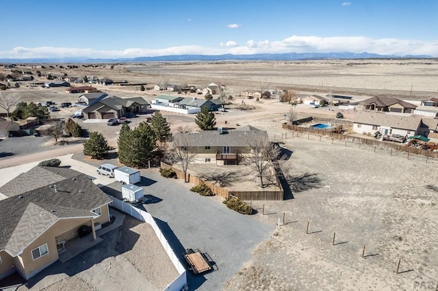 bird's eye view with a residential view, view of desert, and a mountain view