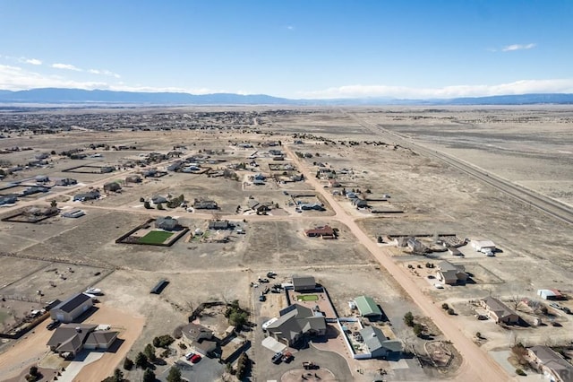 birds eye view of property with view of desert and a mountain view