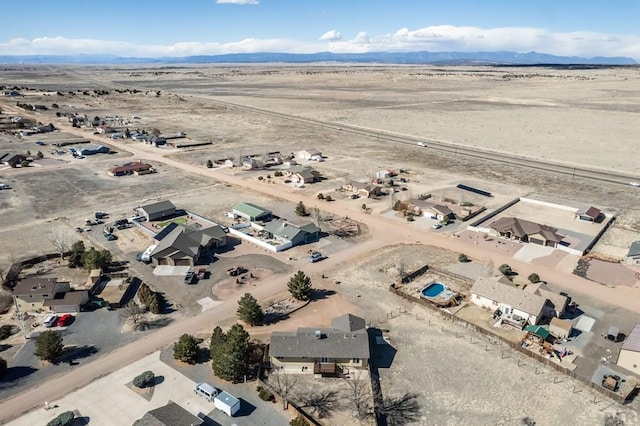 birds eye view of property featuring a desert view and a mountain view